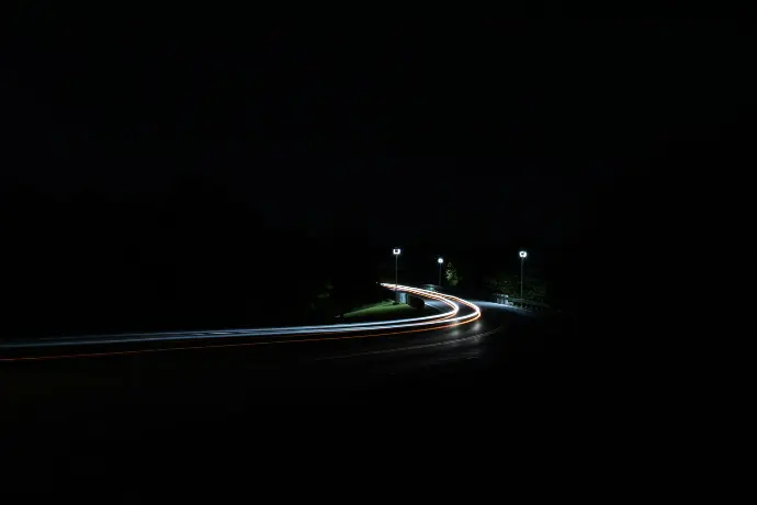 time-lapse photography of moving vehicles on road